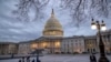 People walk by the U.S. Capitol in Washington, Jan. 21, 2018.