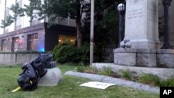 A toppled Confederate statue lies on the ground, Aug. 14, 2017, in Durham, N.C. Activists on Monday evening used a rope to pull down the monument outside a Durham courthouse. The Durham protest was in response to a white nationalist rally held in Charlottesville, Va, over the weekend. 