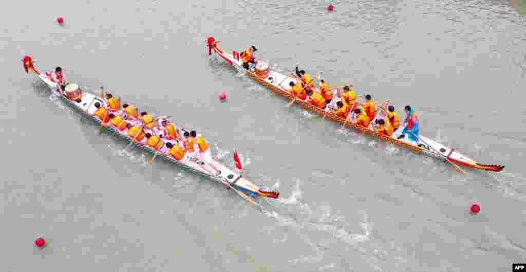 This aerial photo shows teams competing during a dragon boat race ahead of the Dragon Boat Festival in Huaian, in China's eastern Jiangsu province.