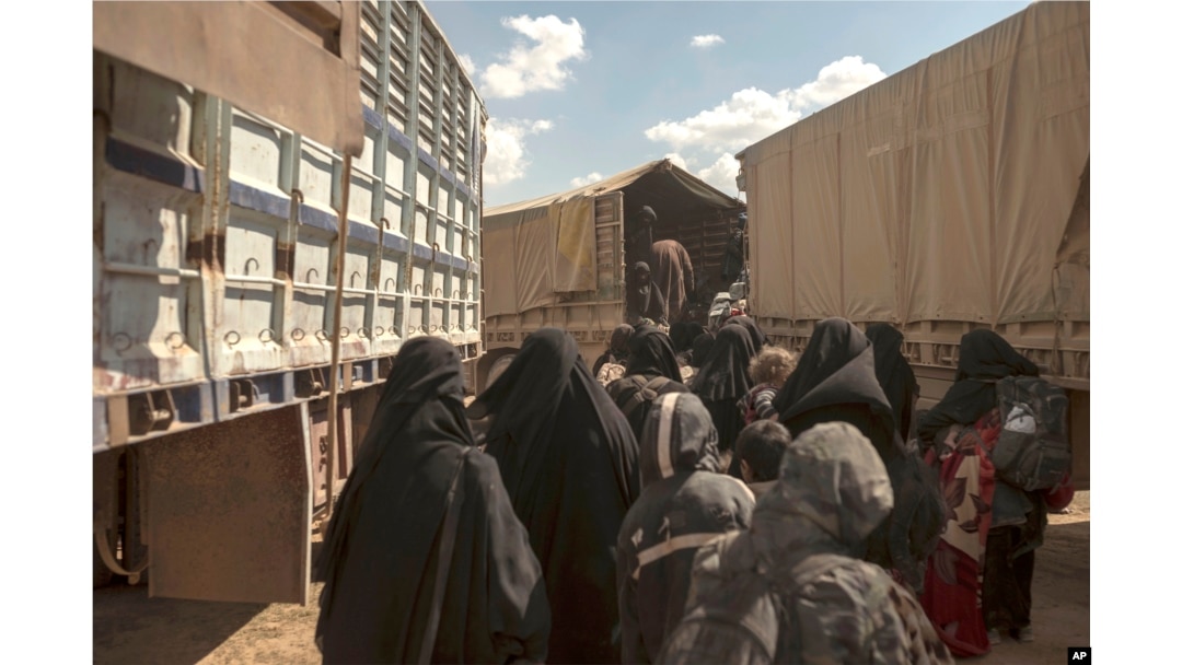 Women and children board a truck at a reception area for people evacuated from the last shred of territory held by Islamic State militants, outside Baghuz, Syria, March 6, 2019.