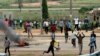 Protesters throw rocks at policemen during an attack on South African business, in Abuja, Nigeria, Sept. 4, 2019. 