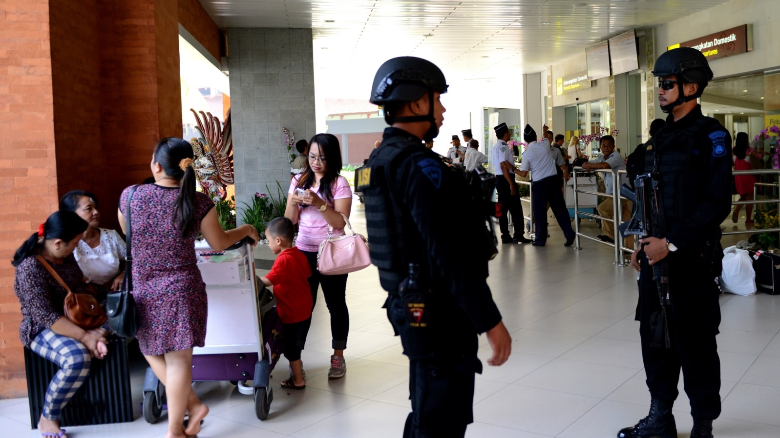 FILE - Indonesian Special Police patrol at Ngurah Rai Airport in Denpasar on Indonesia's resort island of Bali on Jan. 15, 2016.