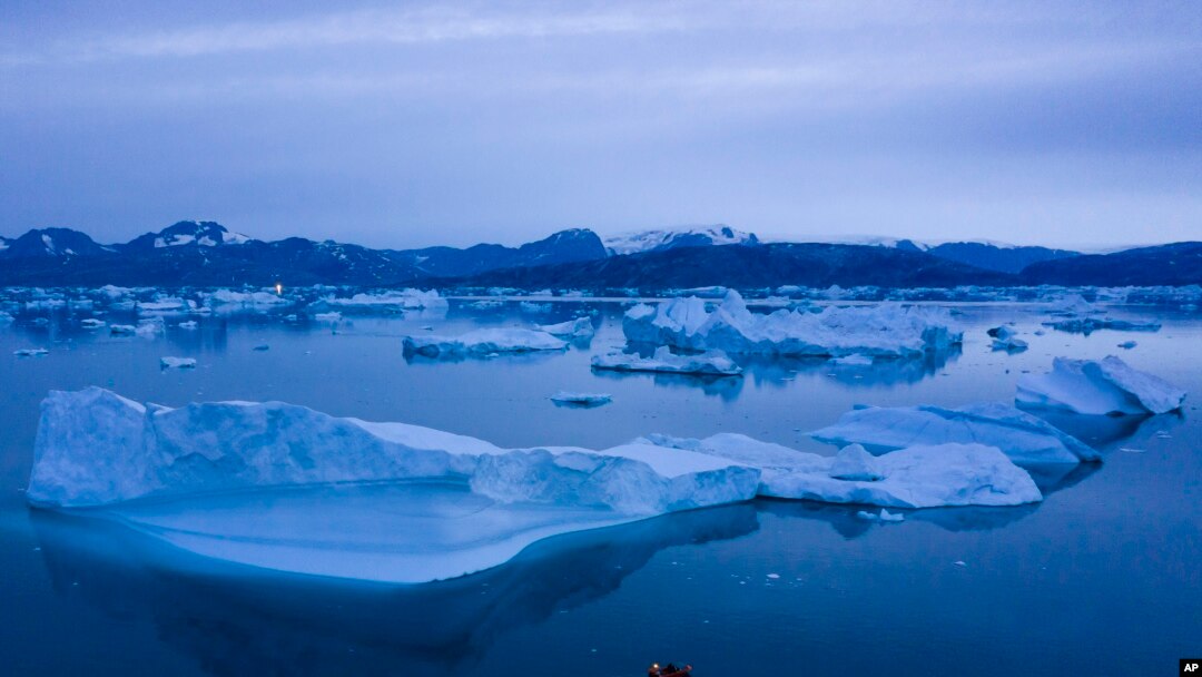 FILE - A boat navigates next to large icebergs near the town of Kulusuk, in eastern Greenland, Aug. 15, 2019. 