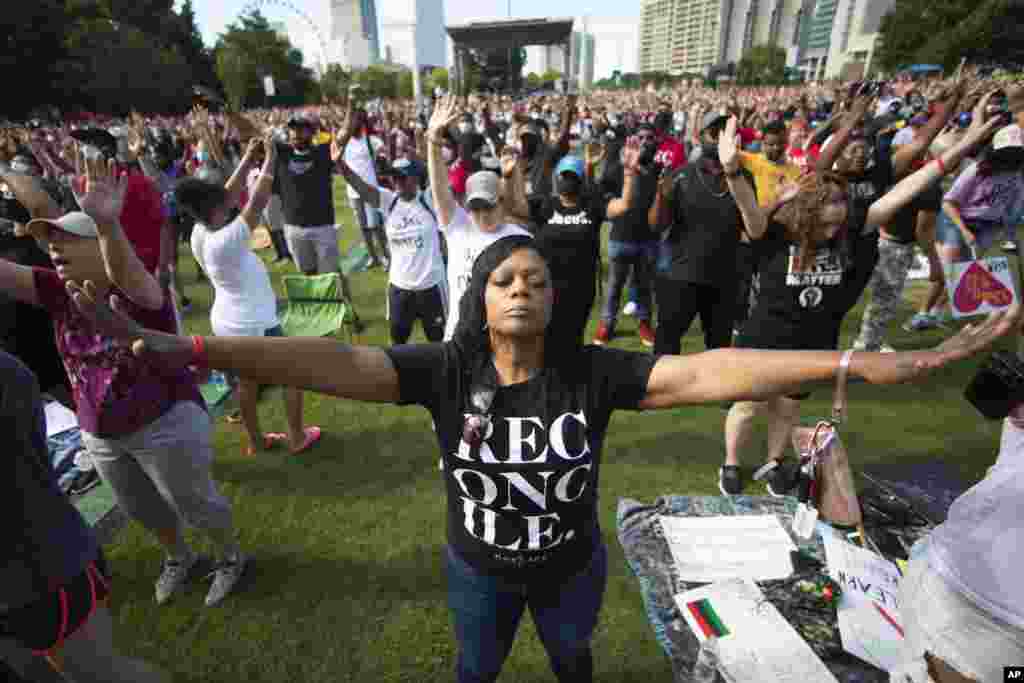 A woman prays during an event hosted by OneRace Movement at Atlanta's Centennial Olympic Park to commemorate Juneteenth, the date of the emancipation of enslaved African Americans in the U.S.