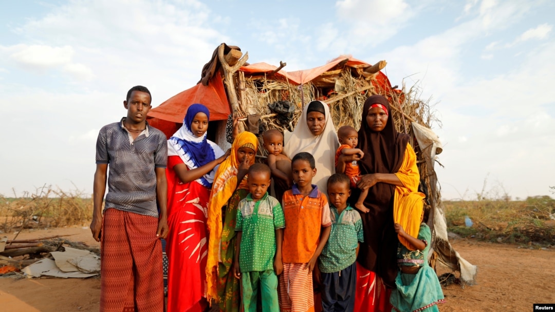 FILE - A family stands beside their shelter at a camp for internally displaced people from drought hit areas in Dollow, Somalia, April 3, 2017. 