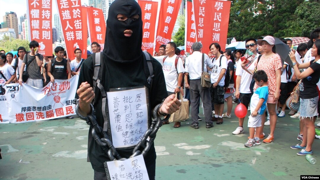 參加729反洗腦國民教育大遊行的示威者身穿黑衣、戴上鎖鏈，喻意國民教育黑箱作業，箝制學生思想
