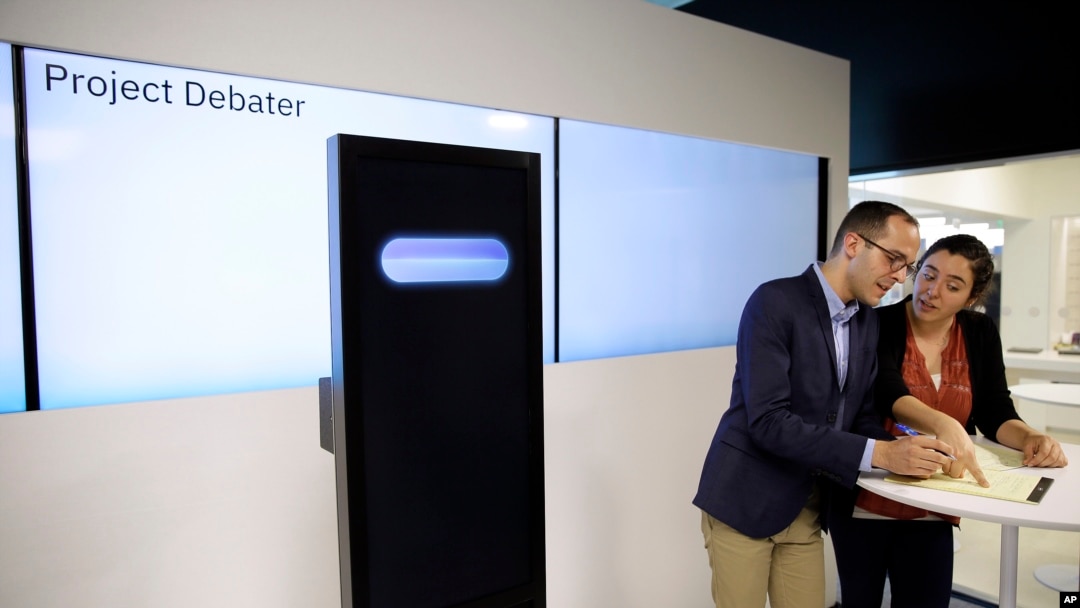 Dan Zafrir, left, and Noa Ovadia, right, prepare for their debate against the IBM Project Debater in San Francisco, June 18, 2018.