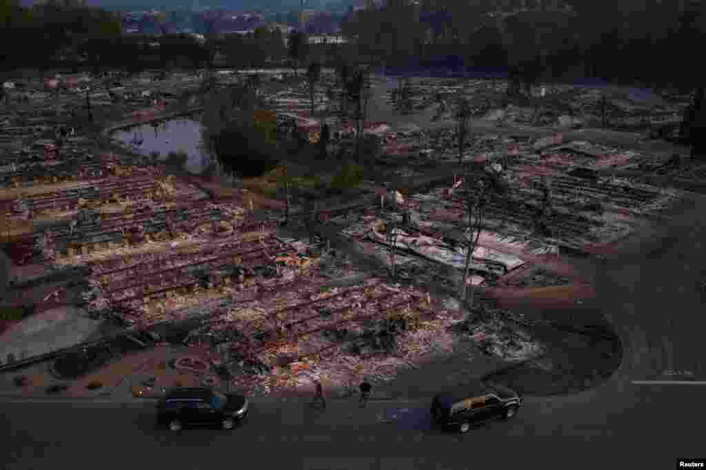 Security officials survey the Bear Lakes Estates neighborhood which was left devastated by the Almeda Fire in Phoenix, Oregon, Sept. 9, 2020.