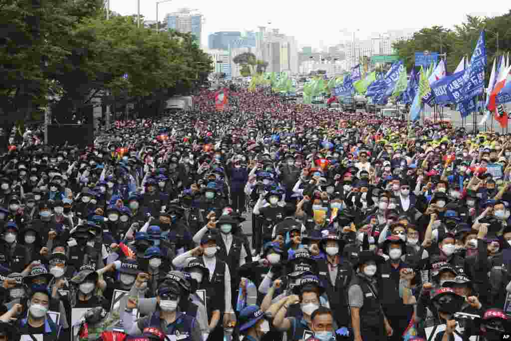 Workers wearing face masks to help protect against the spread of the new coronavirus stage a rally against the government's labor policy in Seoul, South Korea.