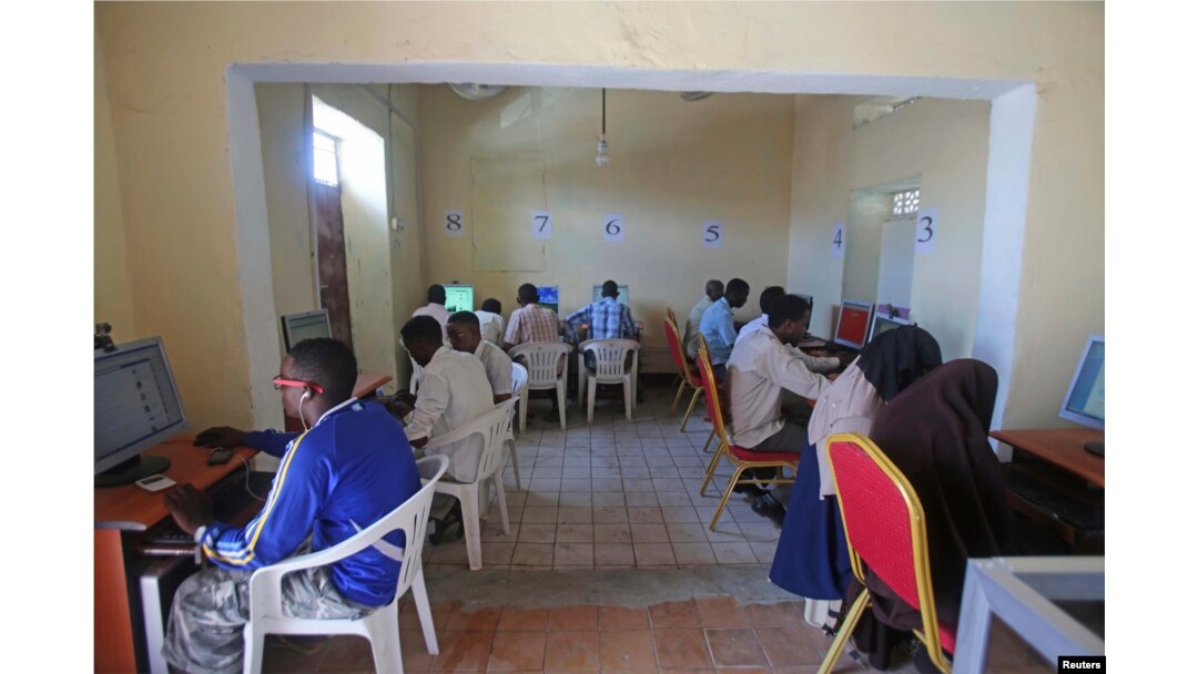 FILE - People use computers at an internet cafe in the Hodan area of Mogadishu, Oct. 9, 2013.