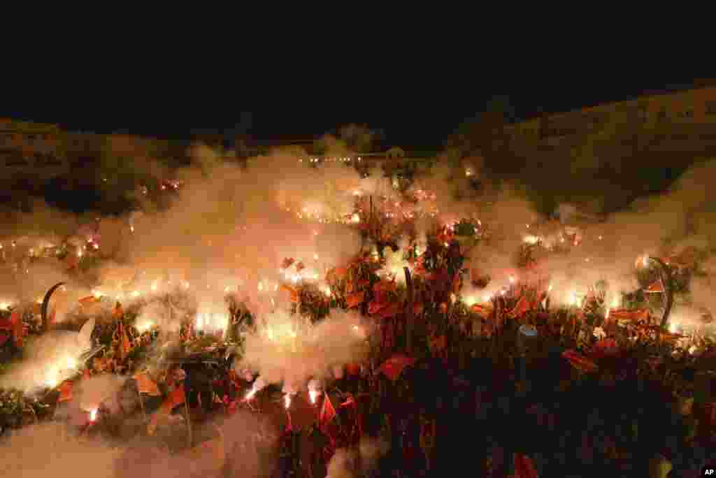 Protesters light torches during a rally in Podgorica, Montenegro, Sept. 6, 2020. Several thousand protesters waving Montenegro flags have gathered in the state capital in support of the ruling pro-Western party.