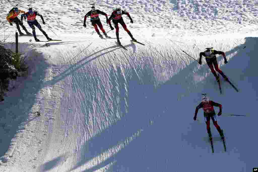 Johannes Dale of Norway, foreground right, Johannes Thingnes Boe of Norway, top right, Tarjei Boe of Norway, 3rd right, Sturla Holm Laegreid of Norway, 3rd left, Lukas Hofer of Italy, 2nd left, and Erik Lesser of Germany compete during the men's 15 km mass start race at the Biathlon World Cup in Hochfilzen, Austria. 