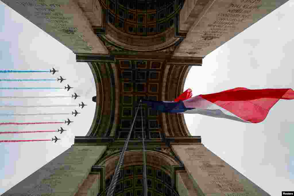 Alpha jets from the French Air Force Patrouille de France fly over the Arc de Triomphe during the Bastille Day celebrations in Paris.