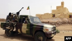 FILE - This file picture dated July 29, 2013 shows Malian soldiers patrolling in Kidal, northern Mali. 