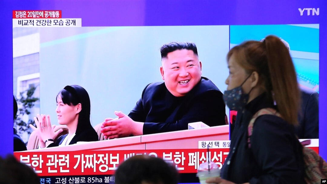 FILE - A woman passes by a TV screen showing an image of North Korean leader Kim Jong Un and his sister Kim Yo Jong during a news program, at the Seoul Railway Station in Seoul, South Korea, May 2, 2020.