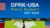 A woman walks past banners for the U.S and North Korean summit at the International Media Center in Hanoi, Vietnam, Feb. 25, 2019.