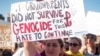 Danielle Nanni holds up a sign while listening to speakers during a rally against hate in Berkeley, Calif., Aug. 27, 2017.