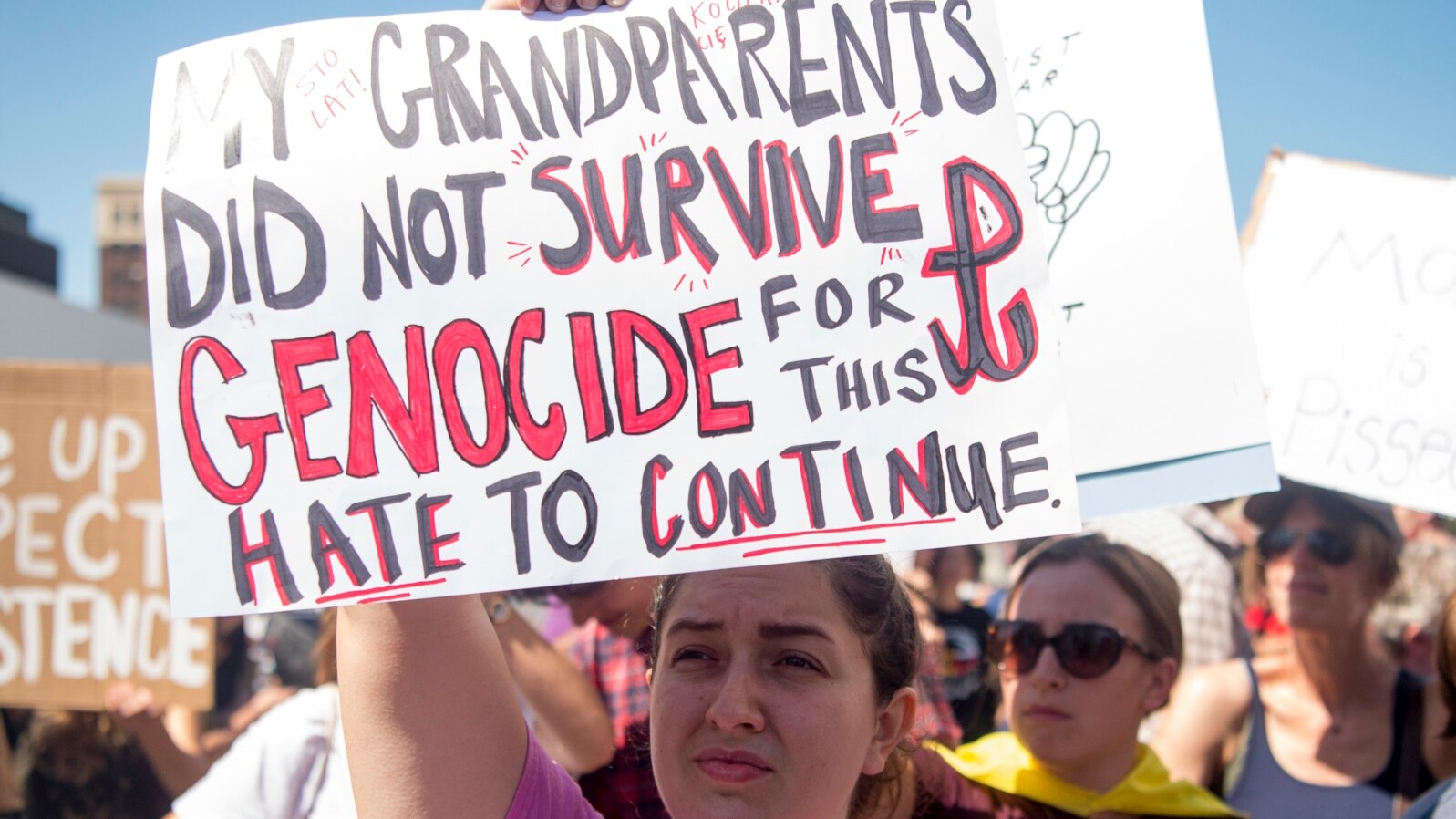 Danielle Nanni holds up a sign while listening to speakers during a rally against hate in Berkeley, Calif., Aug. 27, 2017.
