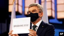 President of the International Olympic Committee Thomas Bach announces Brisbane as the 2032 Summer Olympics host city during the 138th IOC Session at Hotel Okura in Tokyo, Wednesday, July 21, 2021. (Toru Hanai/Pool Photo via AP)
