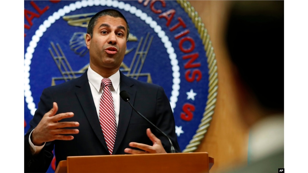 FILE - FCC Chairman Ajit Pai answers a question from a reporter after a meeting in which commissioners voted to end net neutrality, in Washington, Dec. 14, 2017.