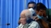 Khieu Samphan, left, the former head of state for the Khmer Rouge, sits in a courtroom during a hearing at the U.N.-backed war crimes tribunal in Phnom Penh, Cambodia, Aug. 19, 2021.
