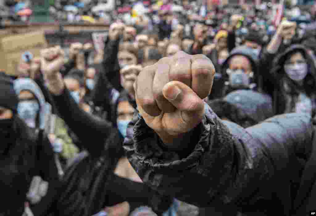 Demonstrators kneel and raise their fists at the Roemerberg square in Frankfurt, Germany, to protest the May 25 death of George Floyd while in police custody in Minneapolis, Minnesota, that has led to protests in many countries and across the U.S.