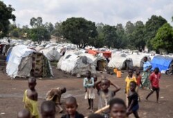 FILE - Congolese victims of ethnic violence are seen at a makeshift camp for the internally displaced people in Bunia, Ituri province in the eastern Democratic Republic of Congo, June 25, 2019.