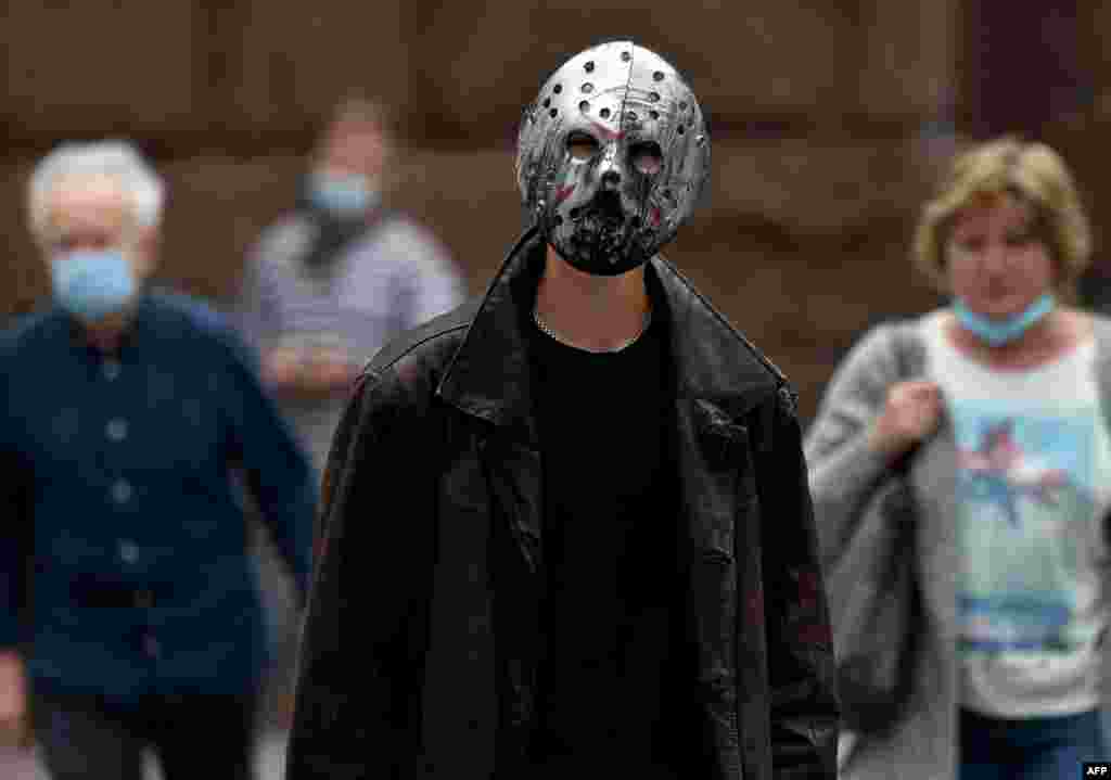 A man wearing an iron mask walks in the center of the Ukrainian capital of Kyiv.
