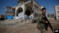 A Turkey-backed opposition fighter of the Free Syrian Army secures the streets of the northwestern city of Azaz, Syria, during a Turkish media tour into northern Syria, March 3, 2018.