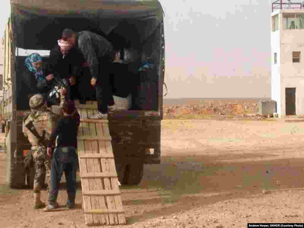 Syrian refugees in eastern Jordan's desert walking the plank into safety.