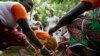 FILE - Ivanka Trump, center, watches as women demonstrate how they process cocoa at Cayat, a cocoa and coffee cooperative, April 17, 2019, in Adzope, Ivory Coast.