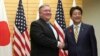 U.S. Secretary of State Mike Pompeo, left, shakes hands with Japanese Prime Minister Shinzo Abe at Abe's office in Tokyo, Oct. 6, 2018.