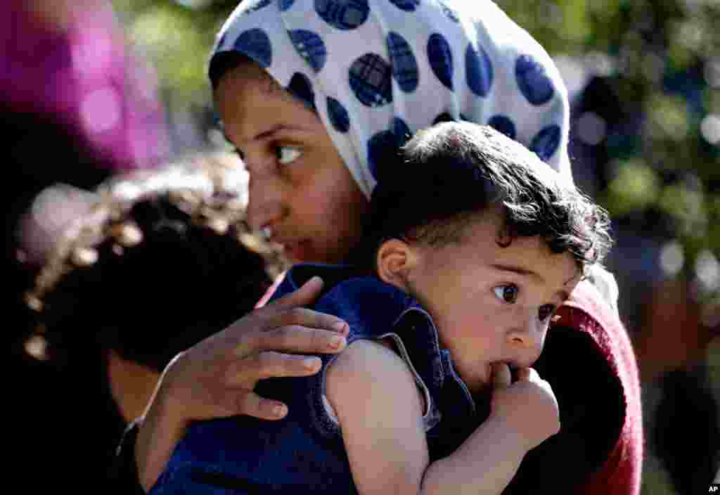 A Syrian refugee carries her sister in Ketermaya village southeast of Beirut, Lebanon, March 14, 2013.