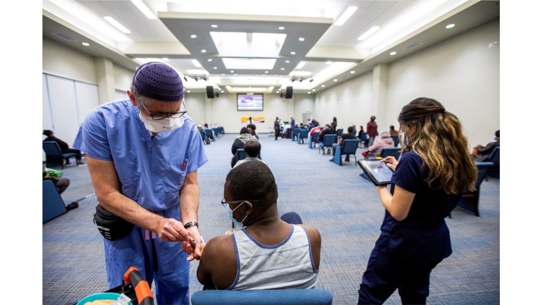 FILE - A health care worker administers the Moderna COVID-19 vaccine at The Church of Pentecost Canada in Toronto, Ontario, Canada, May 4, 2021.