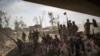 FILE - Iraqi Army soldiers gather to celebrate their gains as their fight against Islamic State militants continues in the Old City of Mosul, Iraq, July 9, 2017.