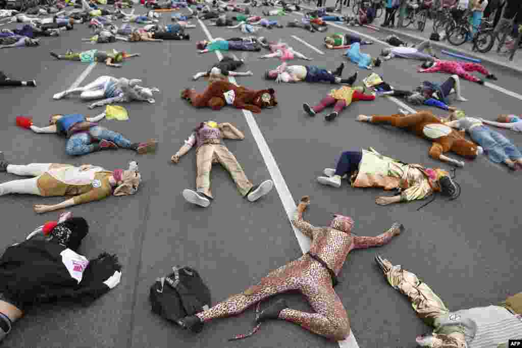 Activists from the Extinction Rebellion movement stage a Die-In as they demonstrate for climate justice in a street in Berlin's Neukoelln district, Germany.