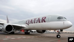 FILE- A Qatar Airways Airbus A350 approaches the gate at the airport in Frankfurt, Germany.