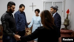 Moroccan Catholics pray in a house used as a church in Ain Atiq district in the outskirts of Rabat, Morocco, June 4, 2018.
