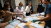 Members of a local electoral commission count ballots at a polling station after polls closed for the municipal elections in Tomsk, Russia, Sept. 13, 2020.