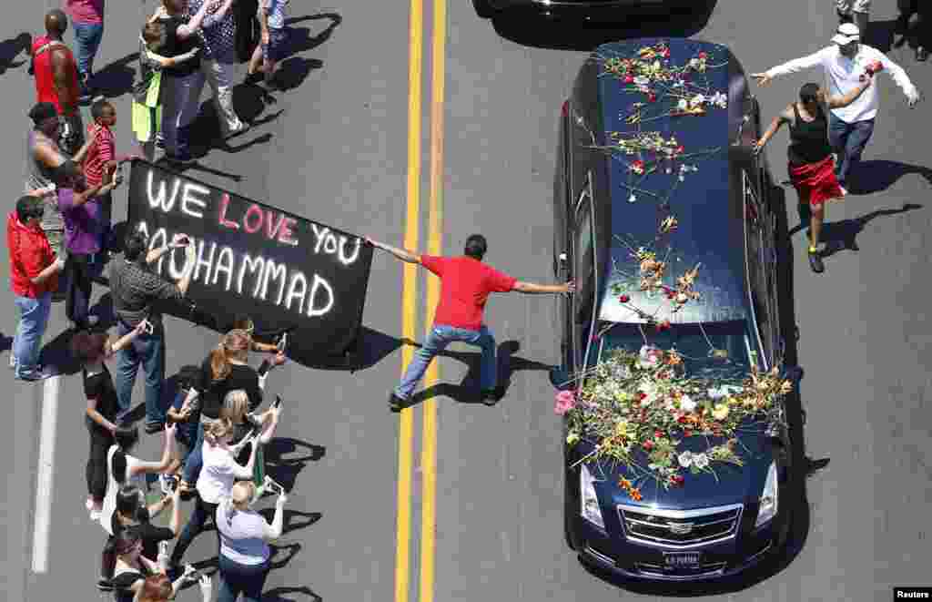 Seorang warga yang menghadiri upacara pemakaman Muhammad Ali berusaha menyentuh mobil yang membawa peti jenazahnya di Louisville, Kentucky, AS.
