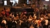 People surround a police van during an opposition protest against the inauguration of Belarusian President Alexander Lukashenko in Minsk, Belarus, Sept. 23, 2020. 