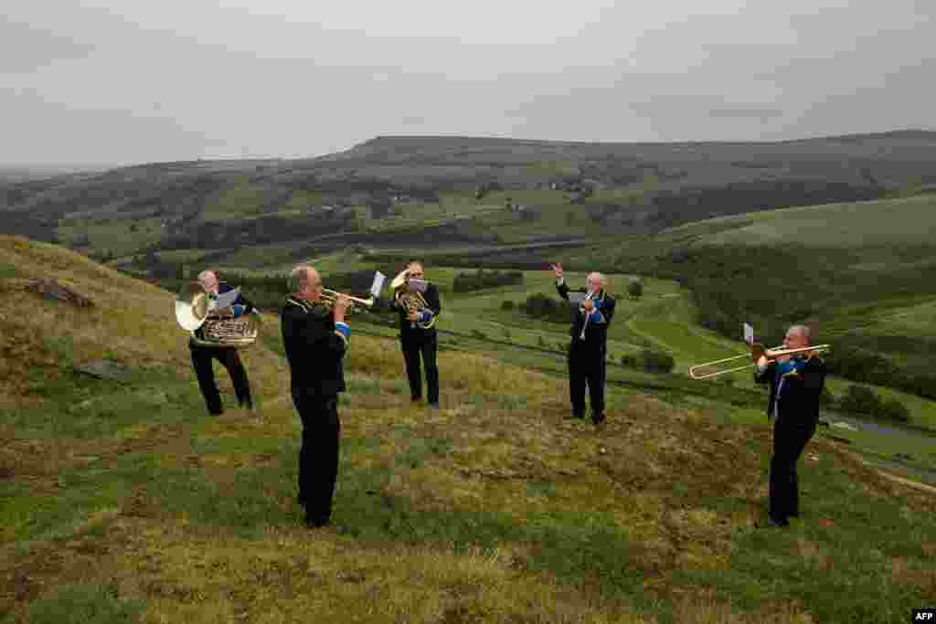 Members of the 'Meltham and Meltham Mills Band' practice together for the first time in Worlow Quarry, above the village of Marsden, near Huddersfield, northern England, June 30, 2020.