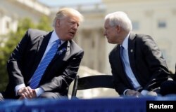 FILE - President Donald Trump speaks with Attorney General Jeff Sessions as they attend the National Peace Officers Memorial Service on the West Lawn of the U.S. Capitol in Washington, U.S.