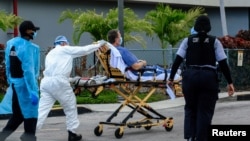 Emergency Medical Technicians (EMT) arrive with a patient at North Shore Medical Center where the coronavirus disease (COVID-19) patients are treated, in Miami, Florida, July 14, 2020.