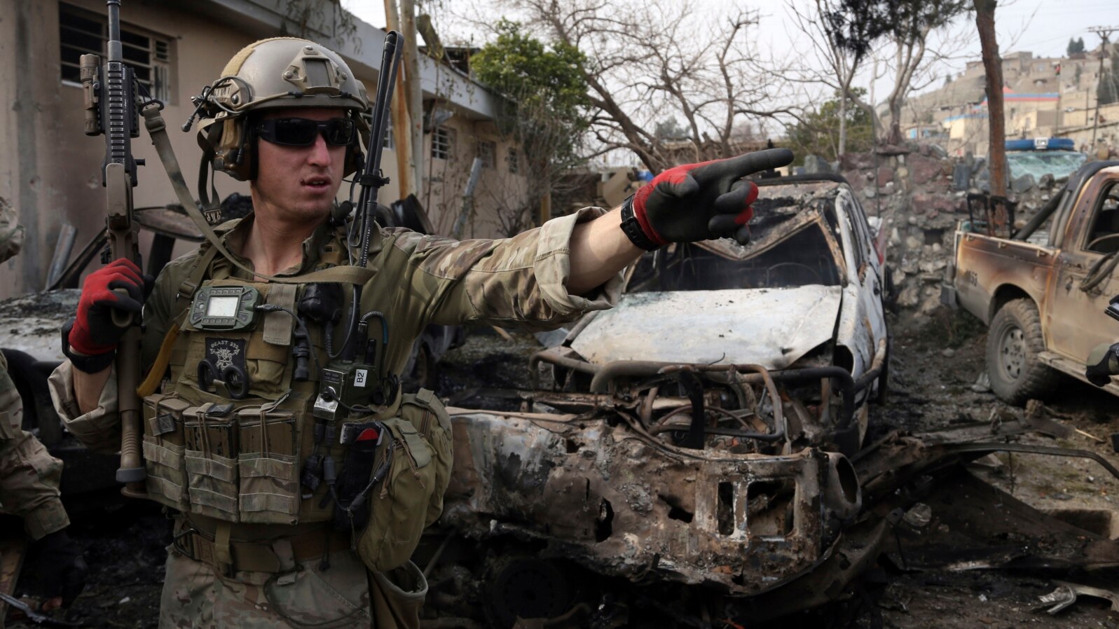 U.S. soldier at site of suicide bombing at police compound in Surobi district of Kabul, Feb. 21, 2014.