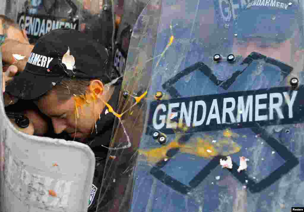 A police officer is thrown by an egg during a scuffle with protesters during an anti-government demonstration in Sofia, Bulgaria.