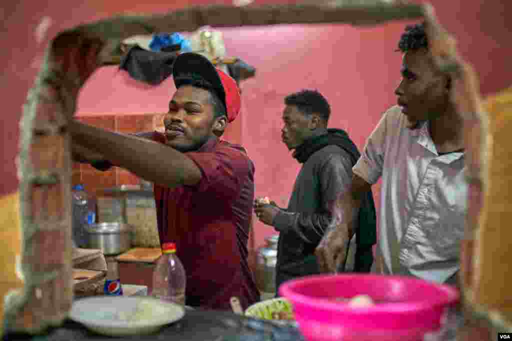 Motasim, a worker at the Sudanese restaurant El Gharb, says, "We offer a big meal for four persons, just for $2, but for free for those who cannot afford it". (H. Elrasam/VOA)