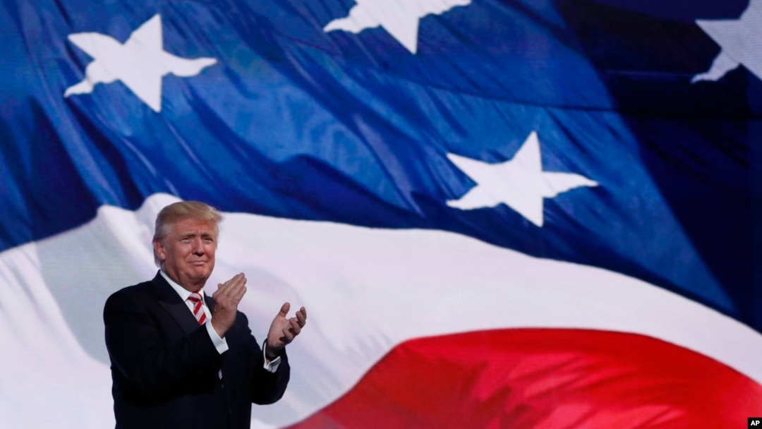 Presidential candidate Donald Trump greets his running mate, Indiana Gov. Mike Pence, onstage at the Republican National Convention in Cleveland, Ohio, July 20, 2016. 