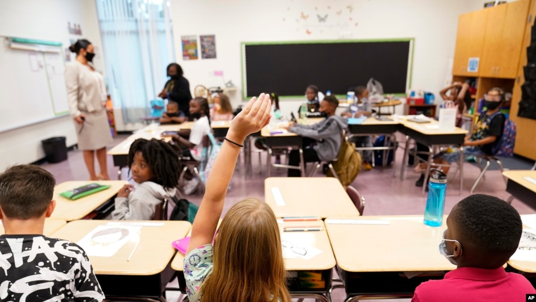 FILE - A student raises their hand in a classroom at Tussahaw Elementary school Aug. 4, 2021, in McDonough, Georgia.