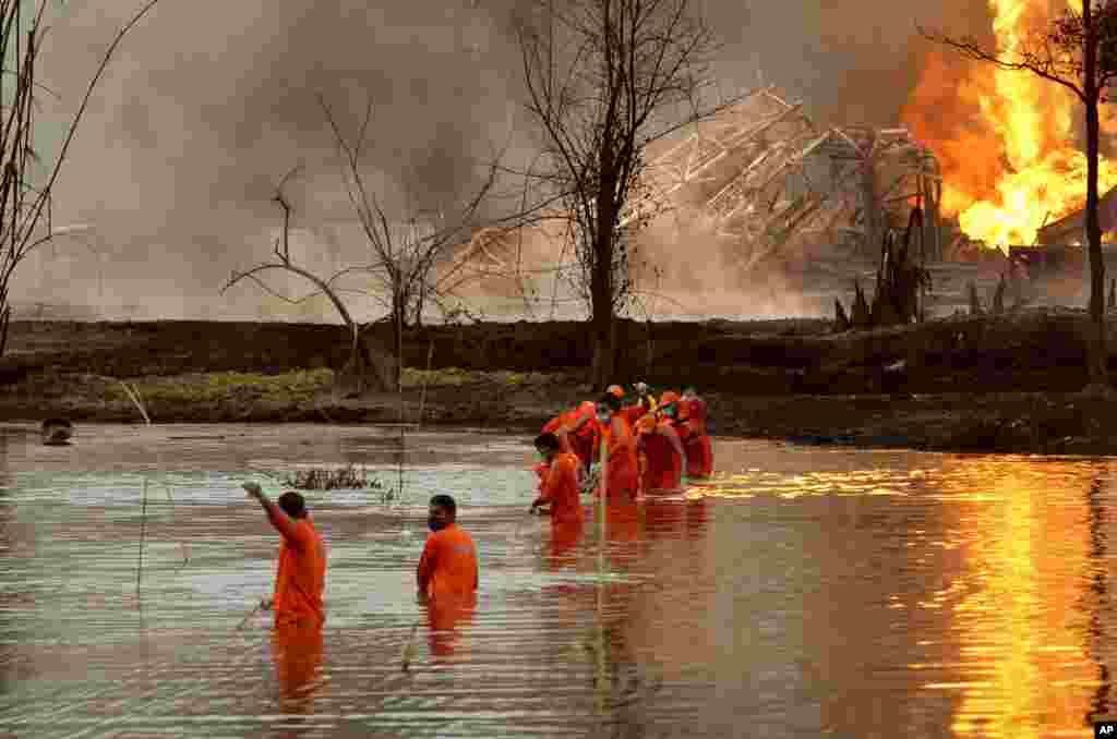National Disaster Response Force personnel participate in a rescue operation at the site of an oil well that exploded and caught fire at Baghjan, Tinsukia district in the northeastern Indian state of Assam, India.